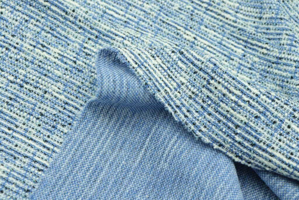 A close up of a blue and white tweed fabric
