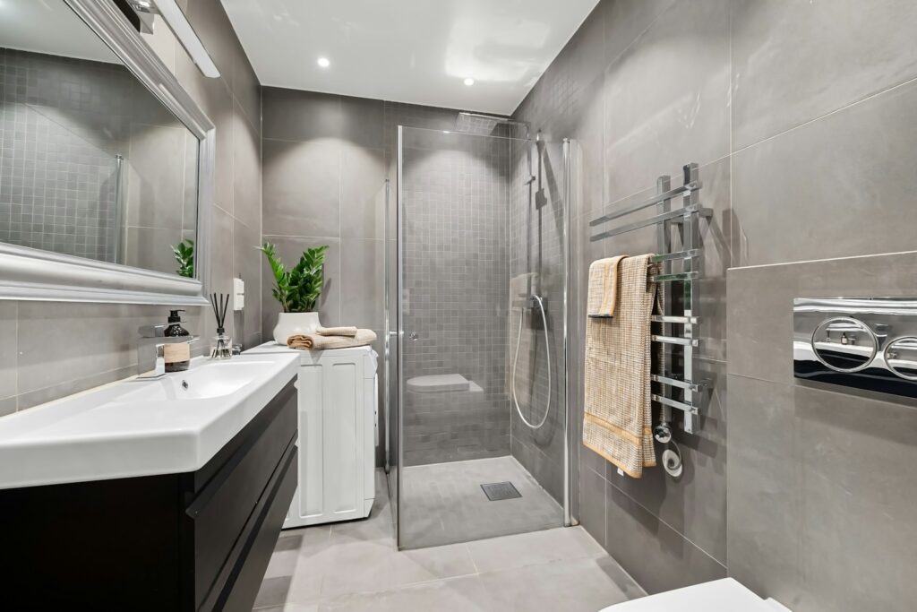 A bathroom with a toilet, sink, and shower