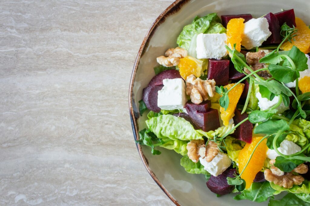 Bowl of vegetable salad with walnuts