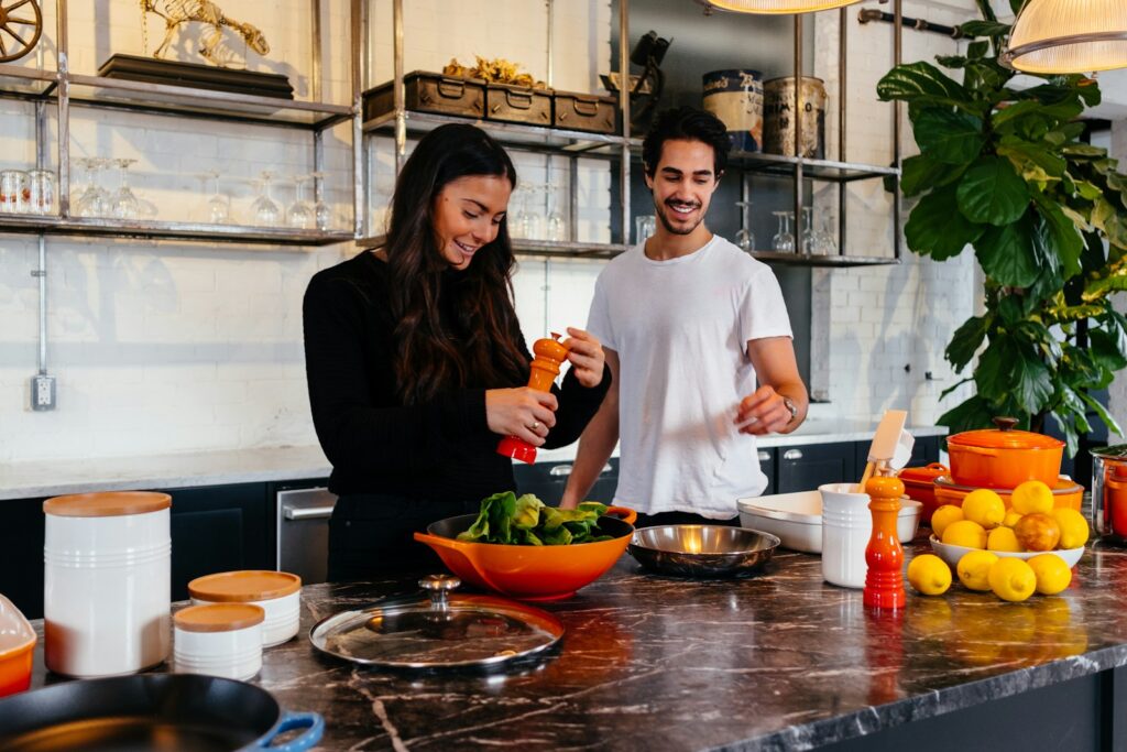 Man and woman standing in front of table
