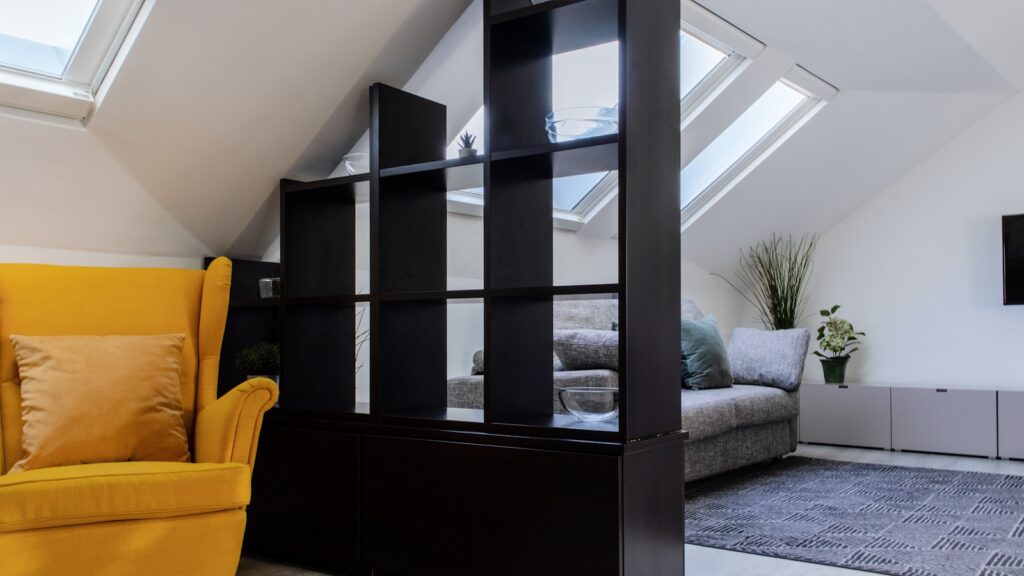 A living room with a yellow chair and a flat screen tv