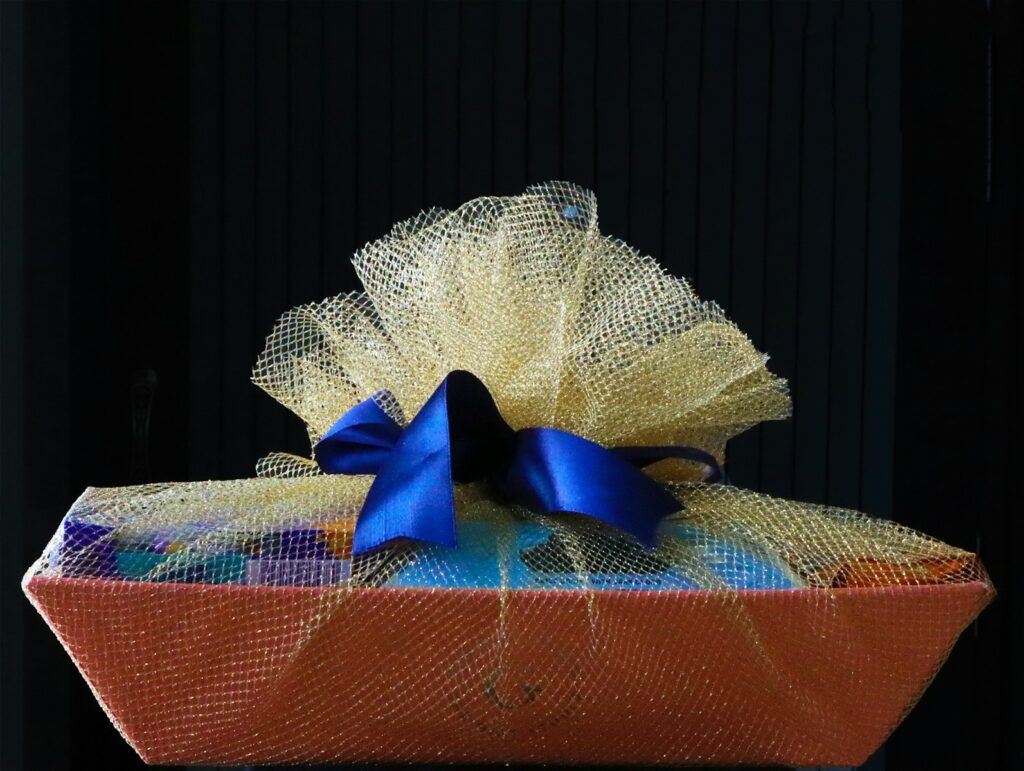 A basket with a blue bow on top of it