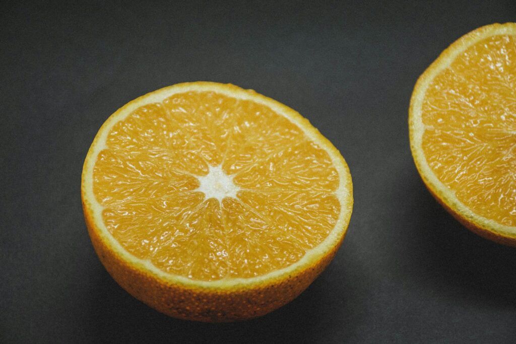 Sliced orange fruit on black textile