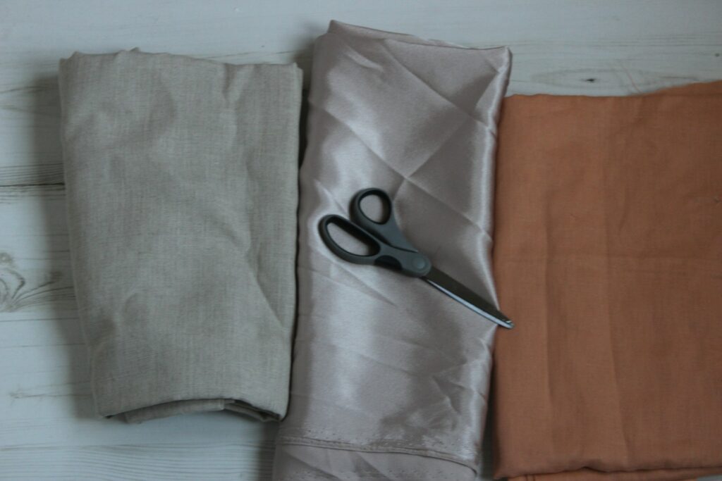 Black scissors on gray textile