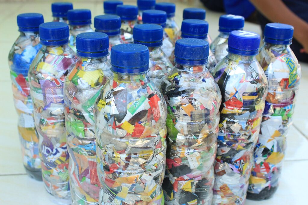 A collection of plastic bottles filled with various items, showcasing creativity in recycling and organization.