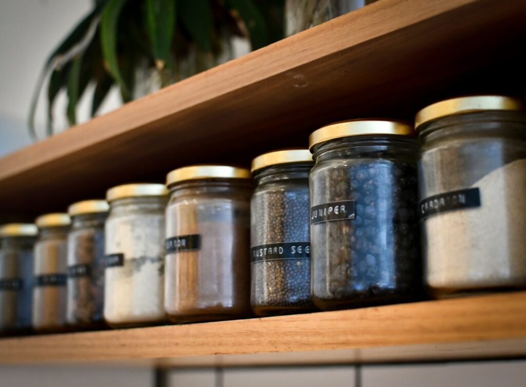 A shelf filled with lots of different types of spices.