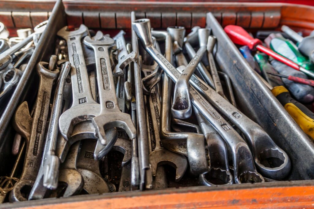 A box filled with lots of wrenches and other tools