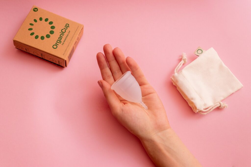 Persons hand on pink surface.