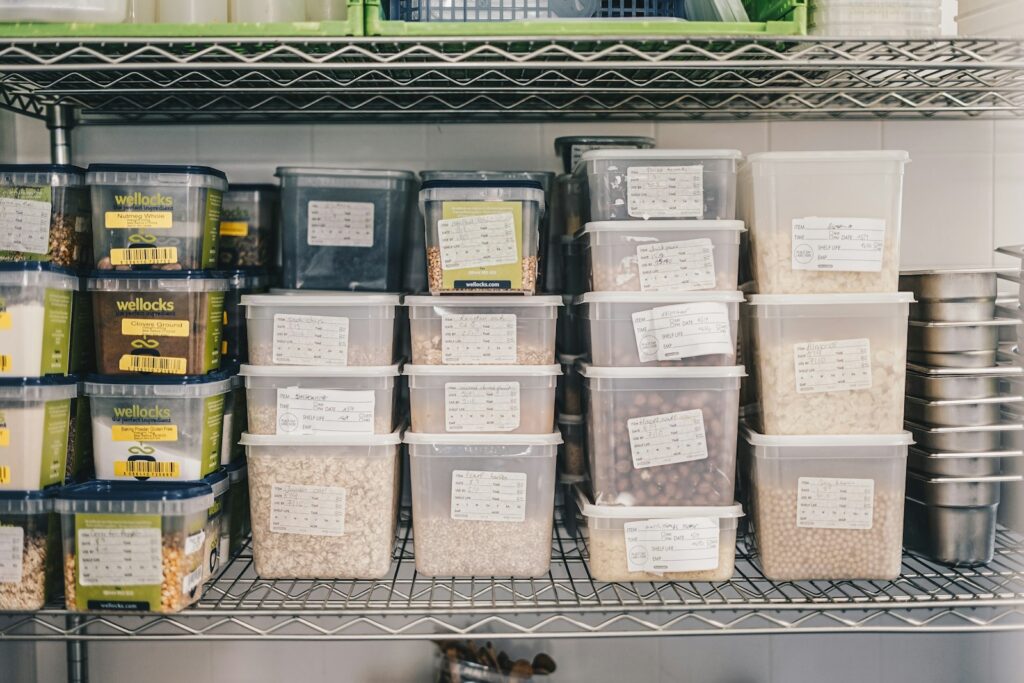 A shelf filled with containers and containers of food