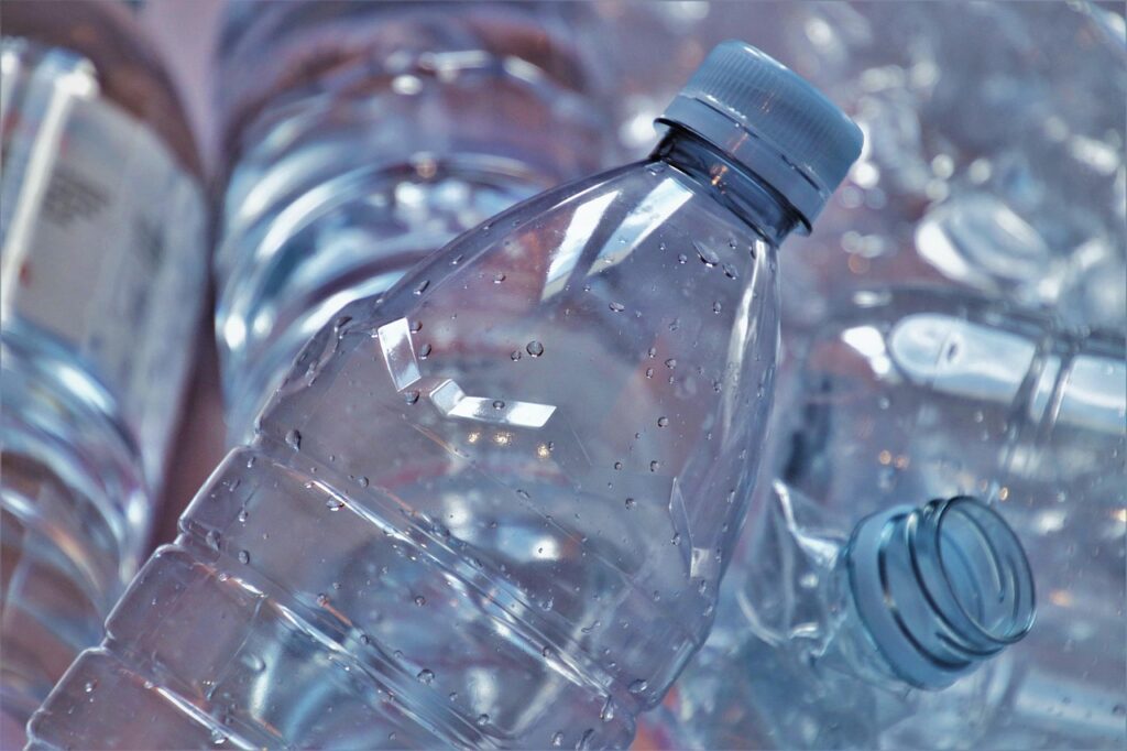 Several plastic bottles in vibrant colors are displayed in a close-up, highlighting their unique designs and materials.