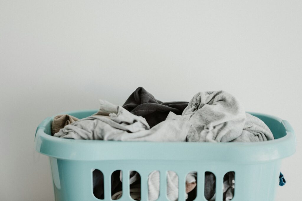 White textile on blue plastic laundry basket.