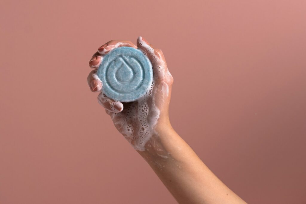 A person holding a soap bar in their hand
