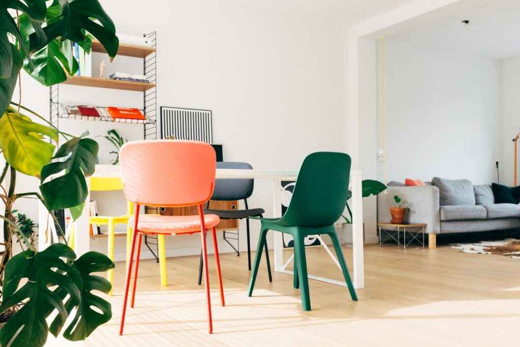 Green and white chair beside white table.
