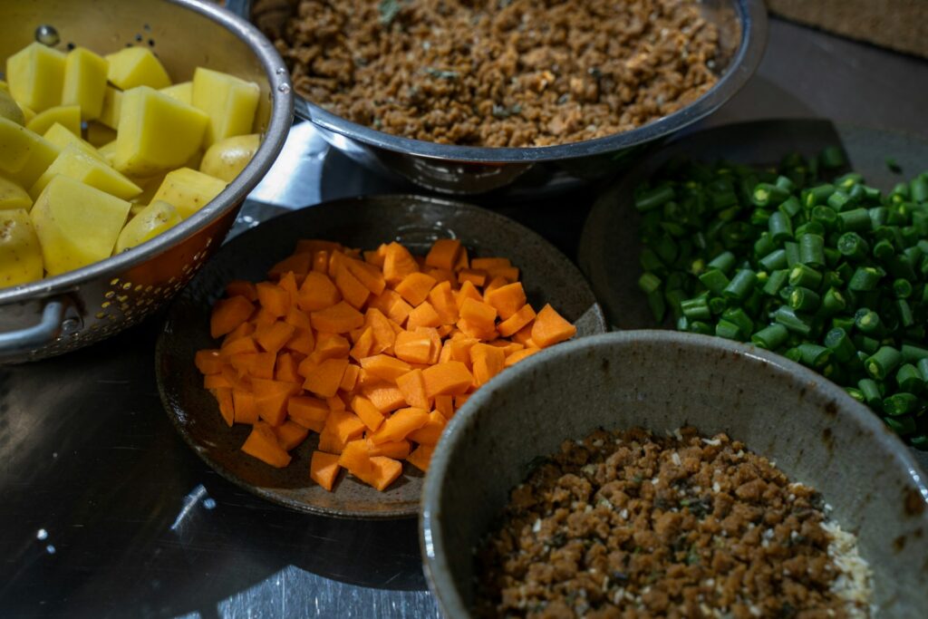 A table topped with bowls filled with different types of food.