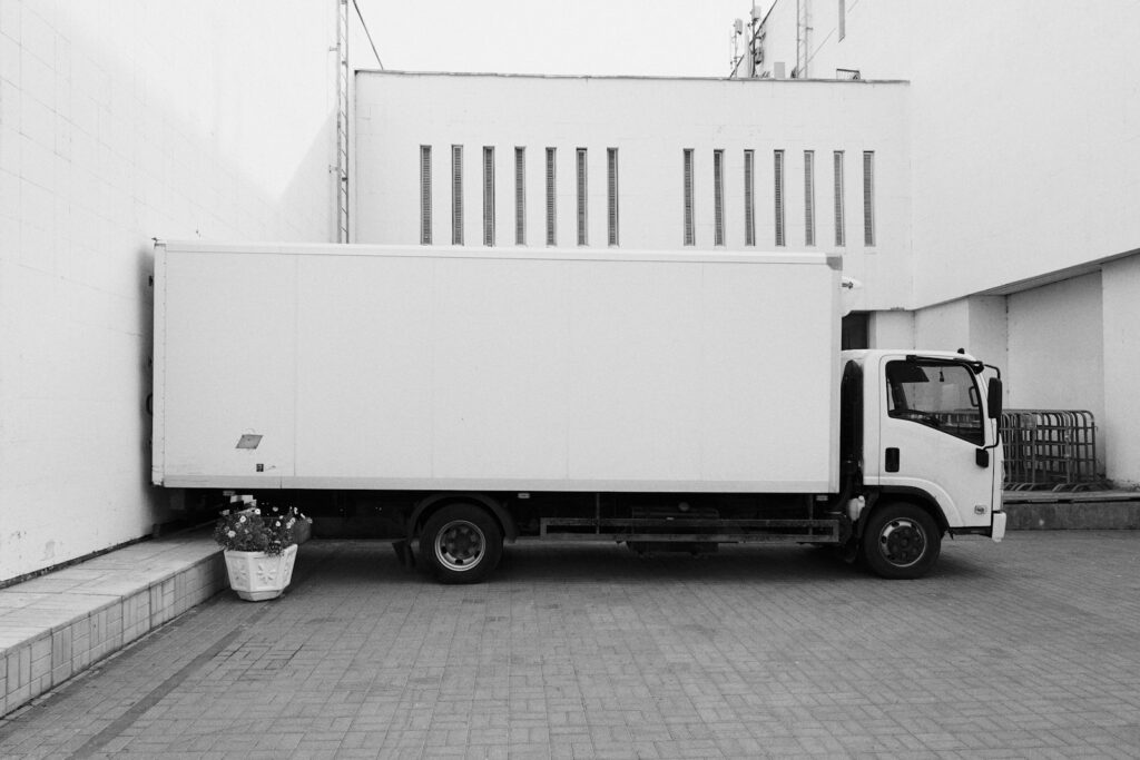 White truck parked near white building.