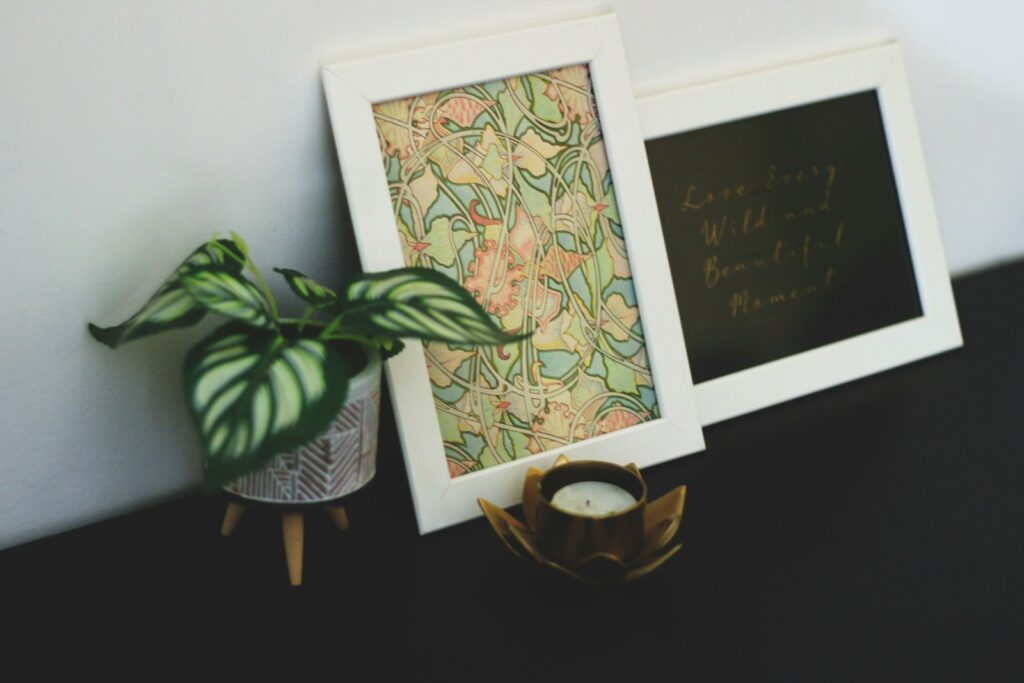 A chalkboard frame and a potted plant on a table.