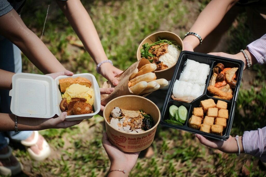 A group of people holding trays of food