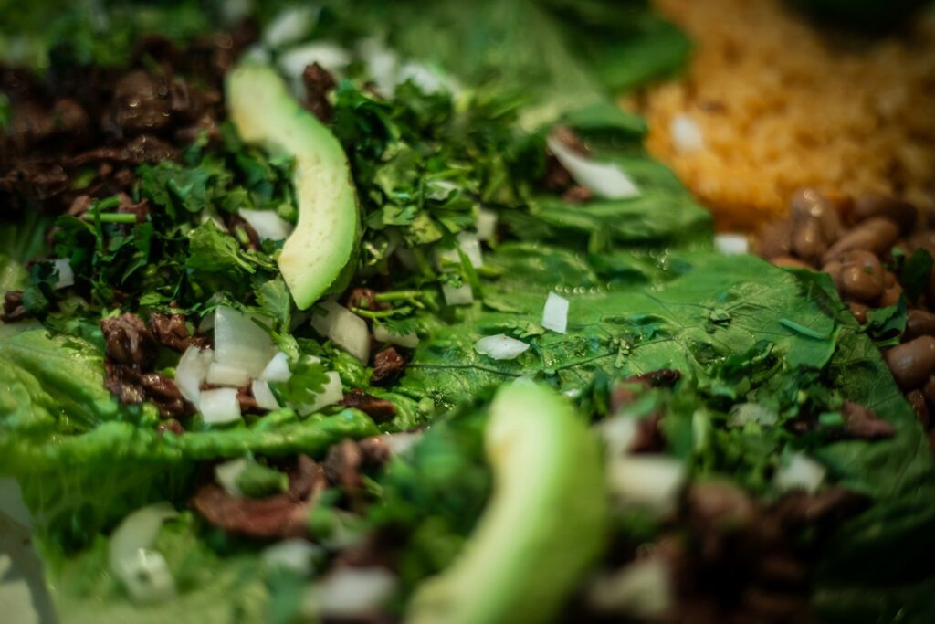 A close up of a salad with lettuce and beans