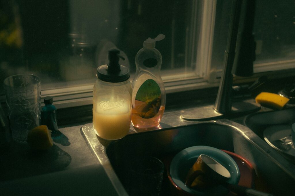 A kitchen sink filled with dishes next to a window.