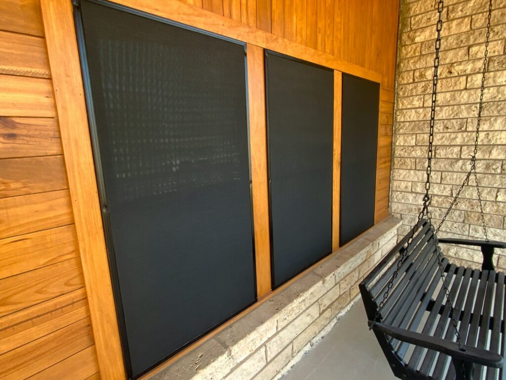 A black bench sitting next to a chalkboard wall.