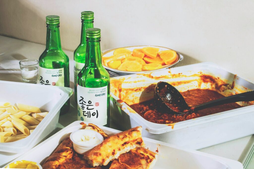Three empty glass bottles and leftover food.