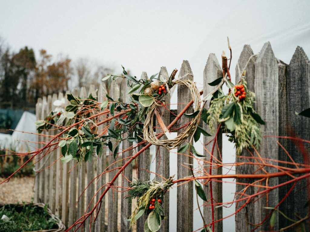 A wooden fence with a wreath on top of it