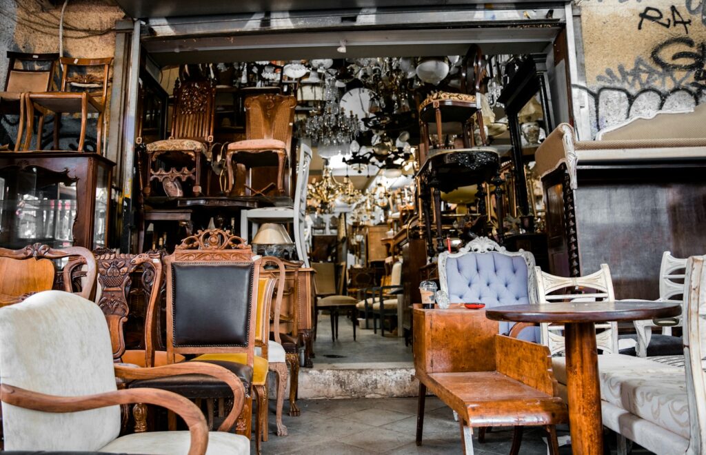 Brown wooden chairs and tables in a thrift shop.