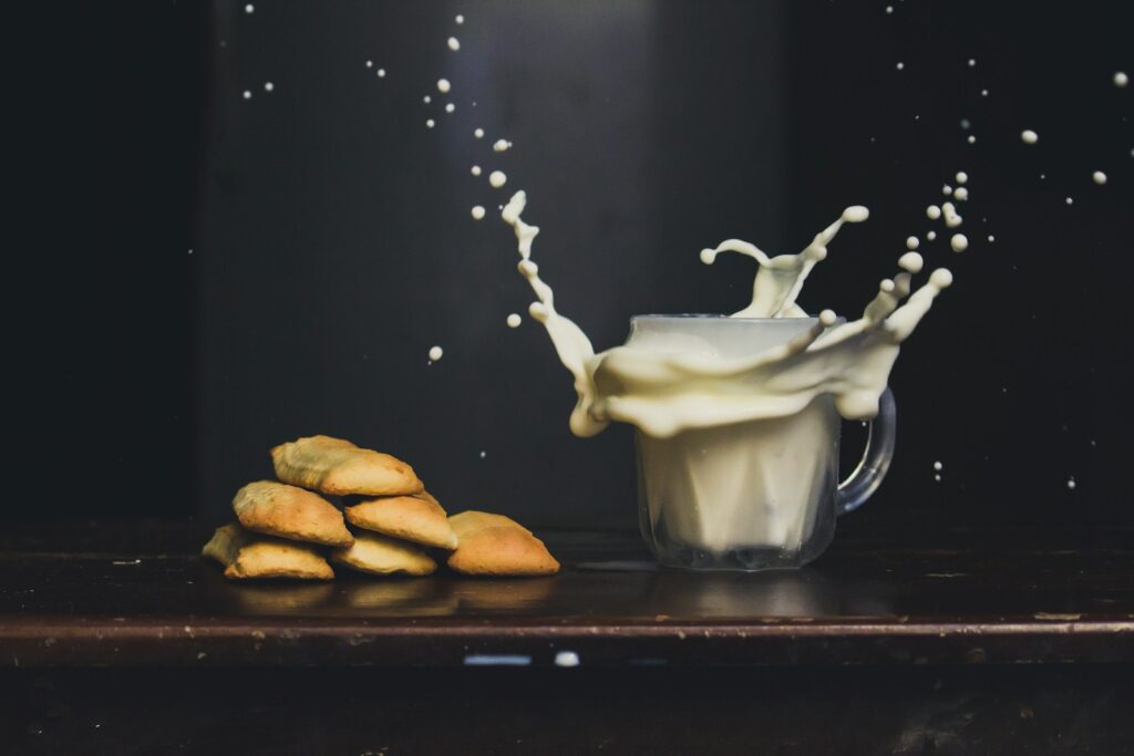 Cashew milk on a mug on top of a brown wooden table.