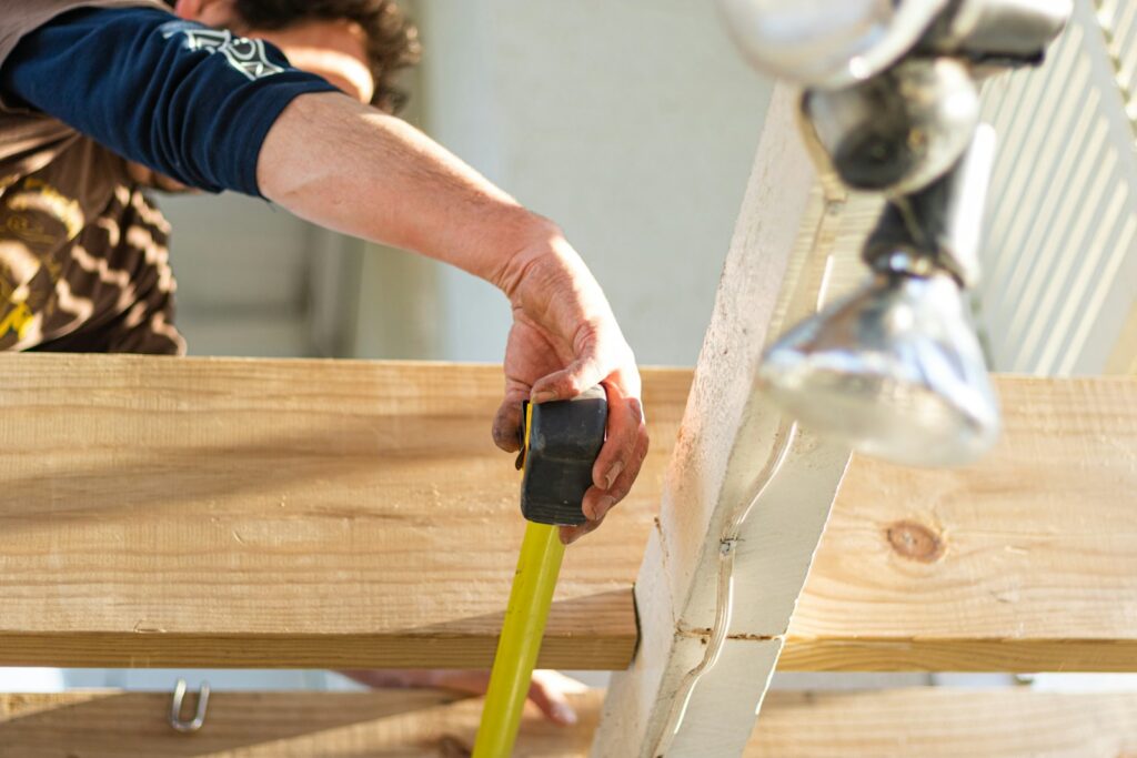 Person holding black and green power tool