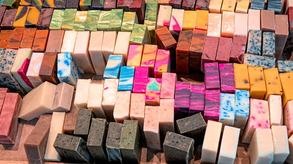 A pile of different colored soaps sitting on top of each other