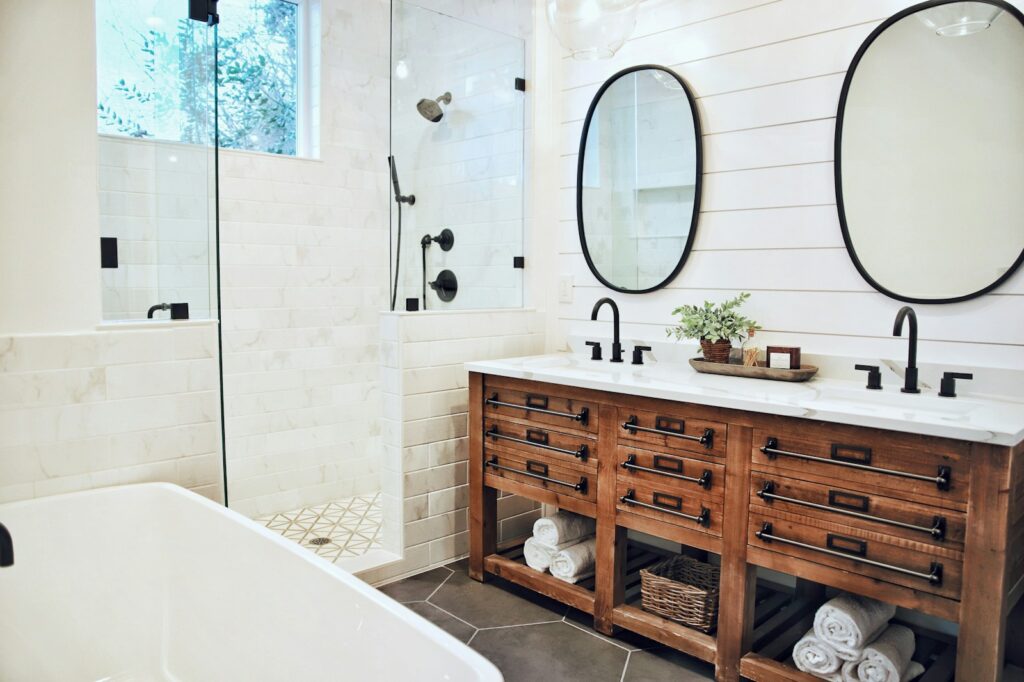 White ceramic bathtub near brown wooden cabinet