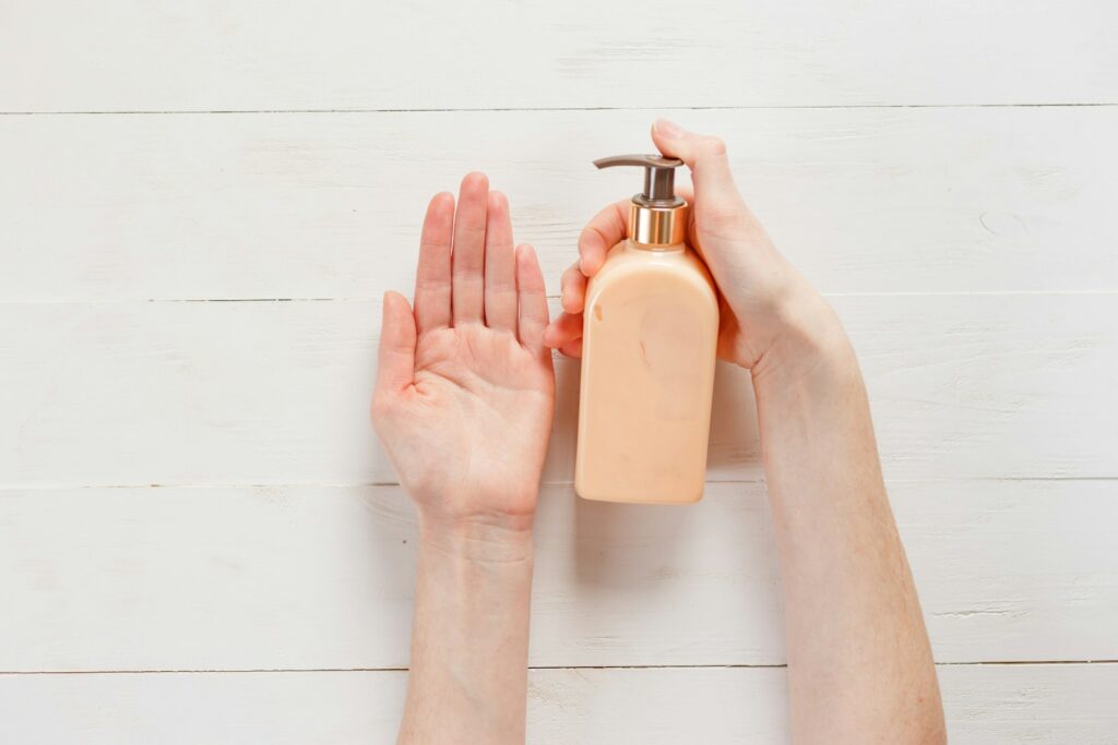 A person holding a shampoo bottle.