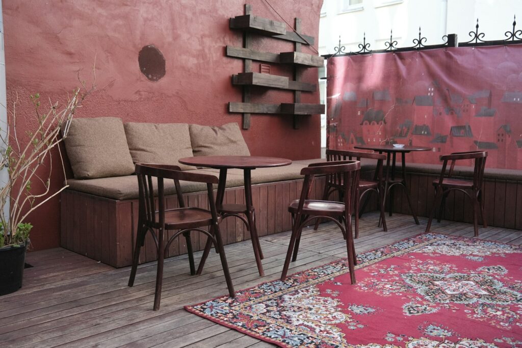 A room with a couch and chairs.