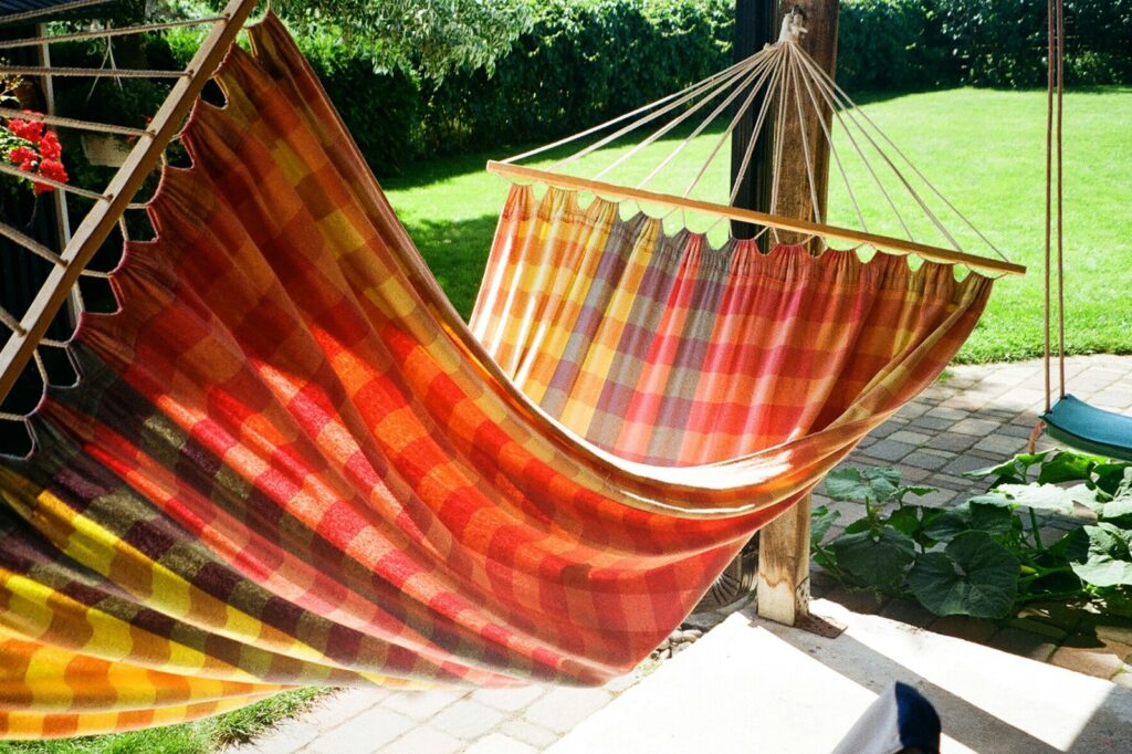 A hammock hanging from a wooden pole.