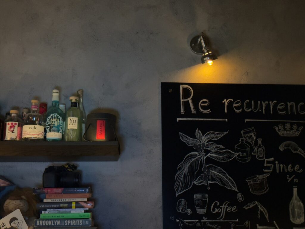 A chalkboard next to a book shelf.
