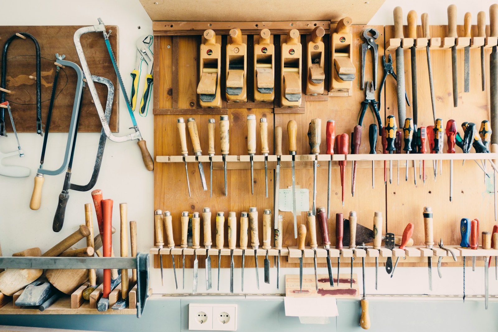 Assorted handheld tools in tool rack