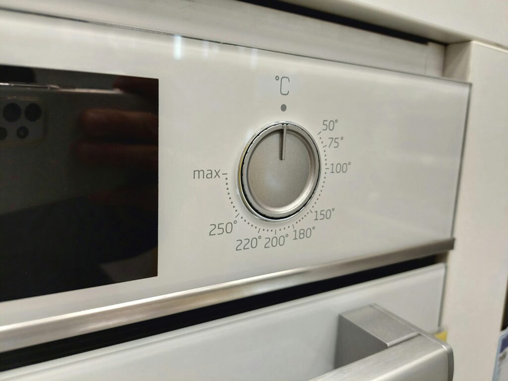A close up of a stove with a knob on it.