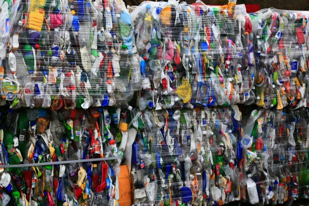 A colorful assortment of plastic bottles stacked in a large pile, showcasing various hues and shapes.