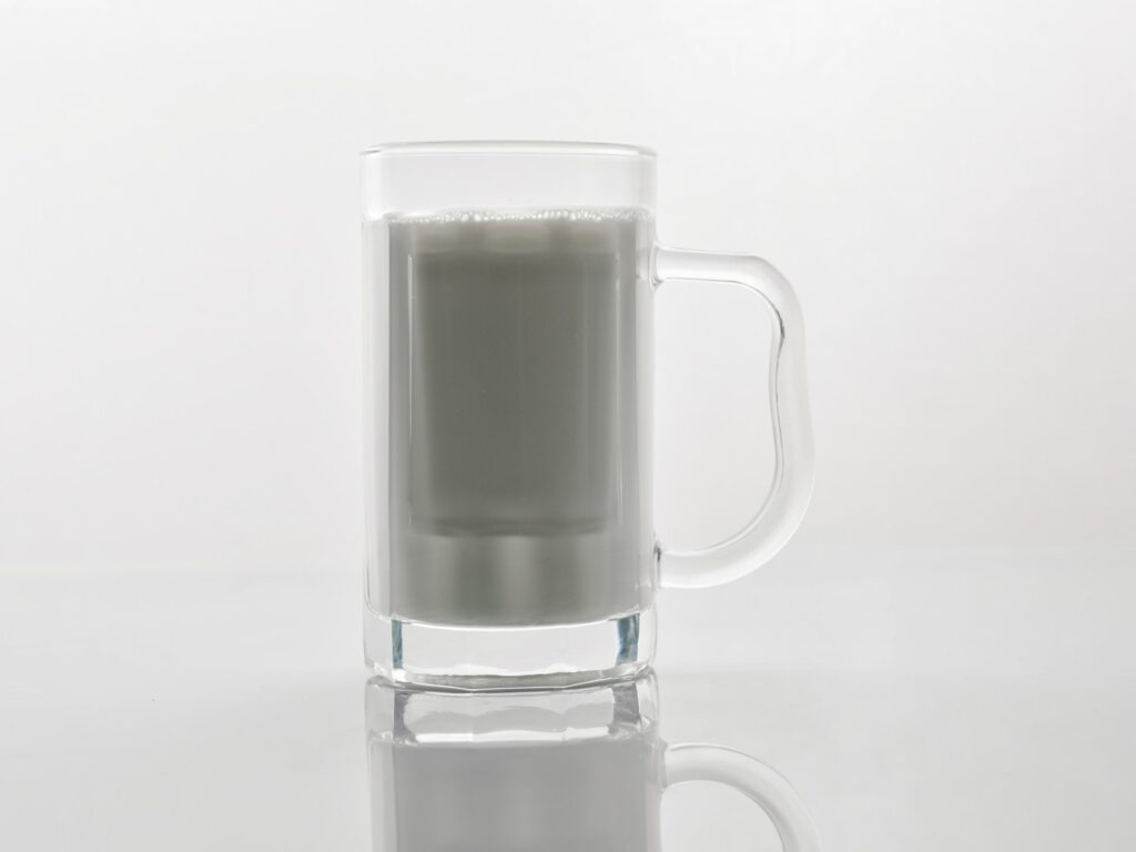 A glass of milk sitting on top of a table.